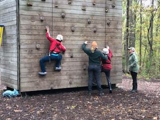Students climbing rock wall